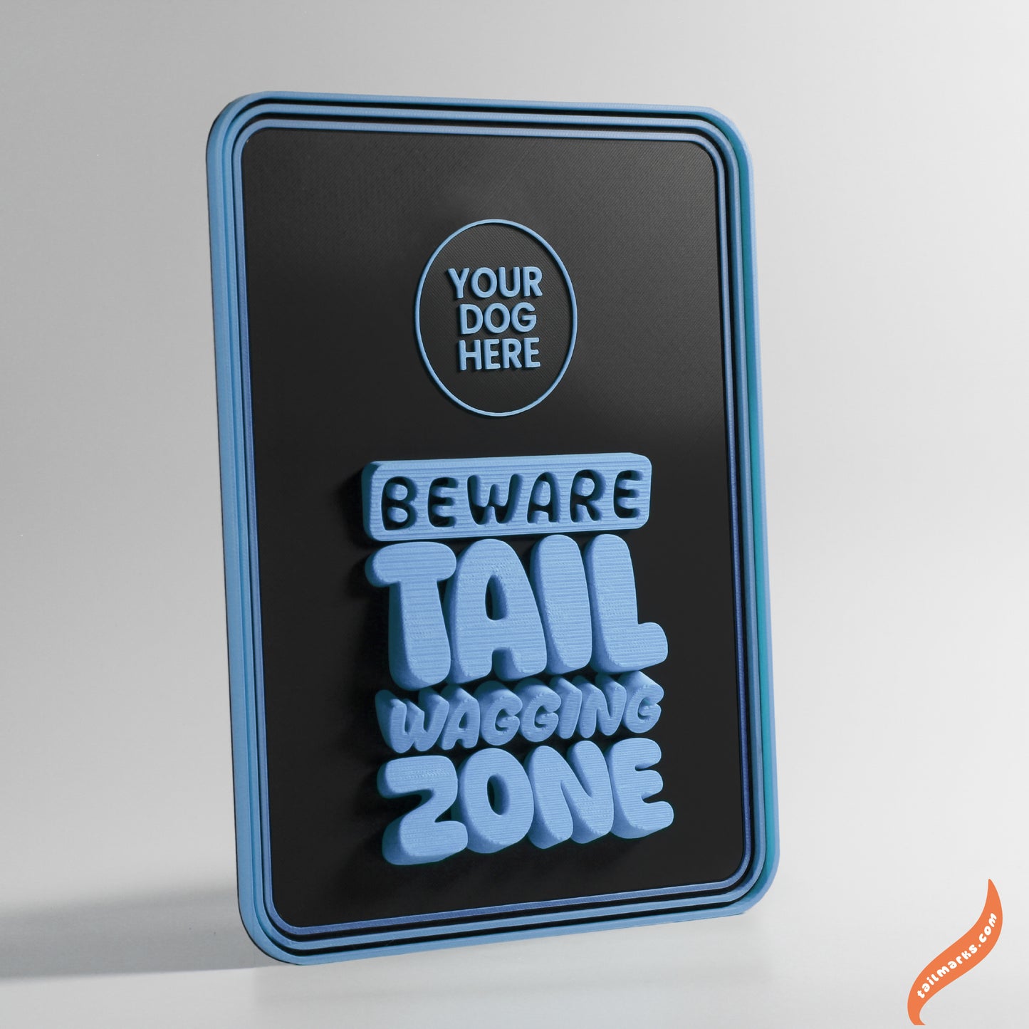 Decorative sign with 'Beware Tail Wagging Zone' text with a round frame on a gray background