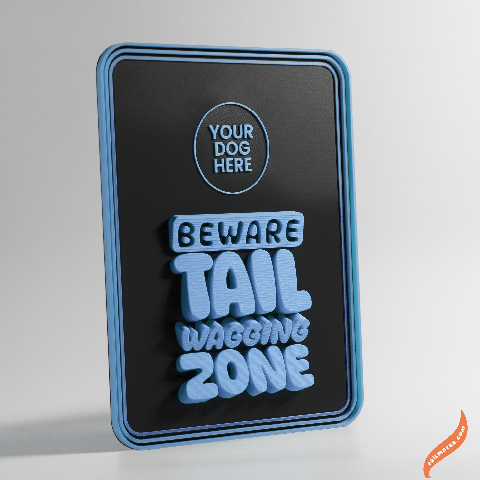 Decorative sign with 'Beware Tail Wagging Zone' text with a round frame on a gray background