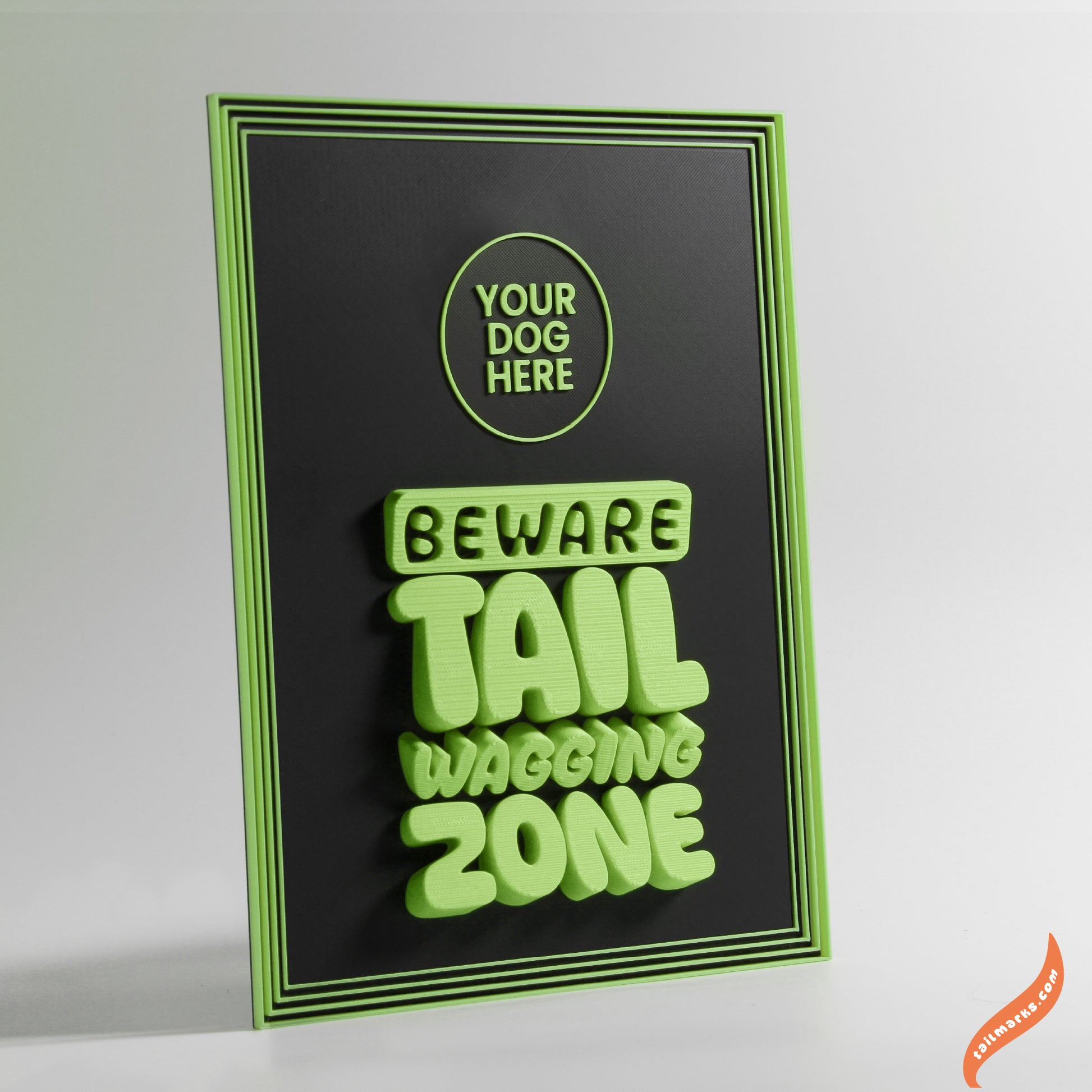 Decorative sign with 'Beware Tail Wagging Zone' green text and a focus frame on a black background
