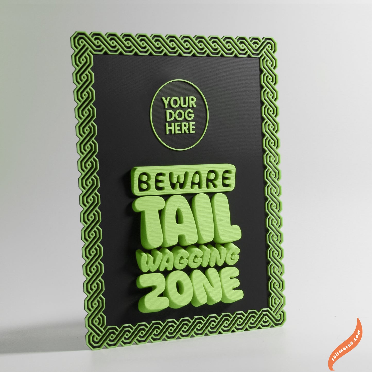 Decorative sign with green text 'Beware Tail Waving Zone' and a maya green frame on a black background.