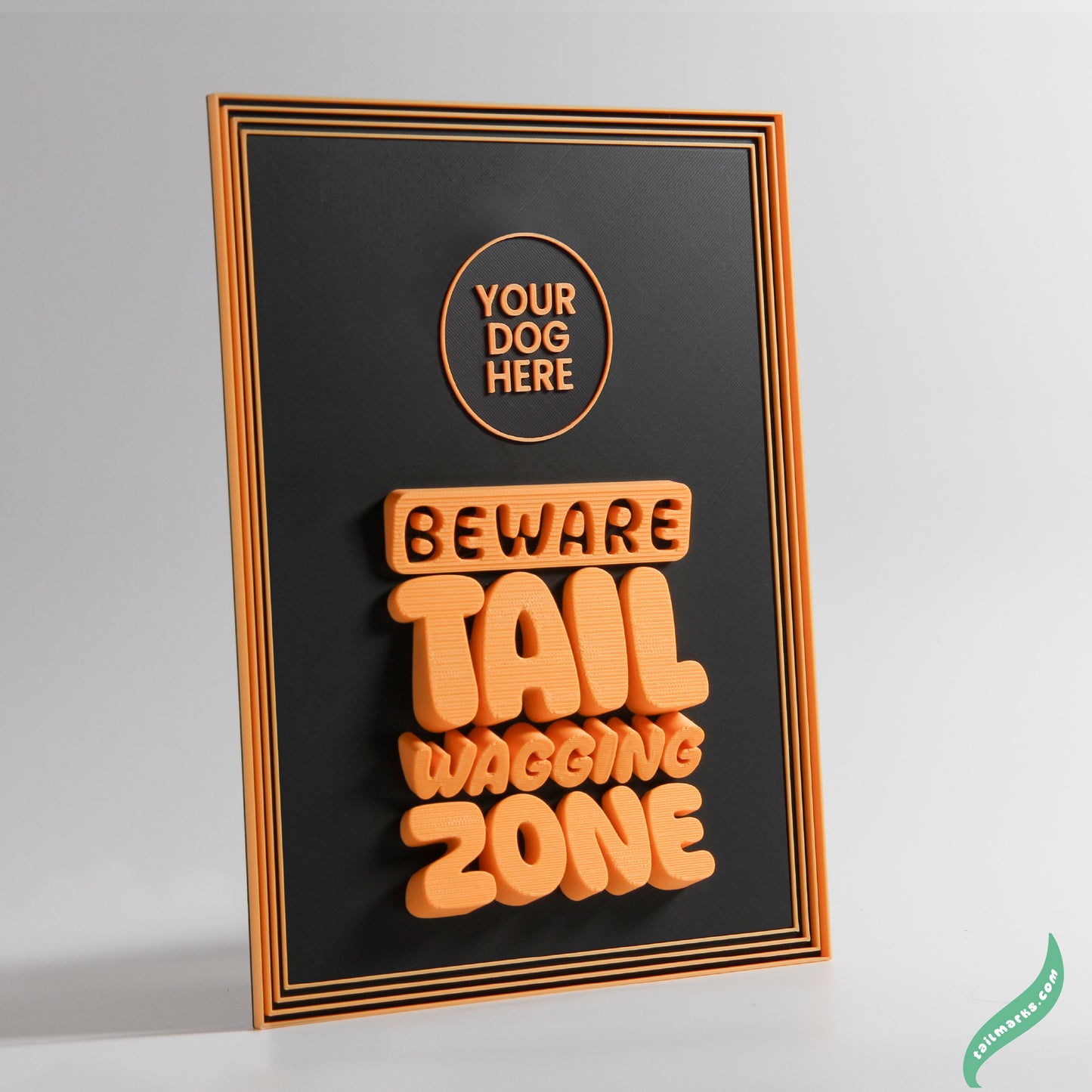 Decorative sign with orange text 'Beware Tail Wagging Zone' and a focus frame on a black background