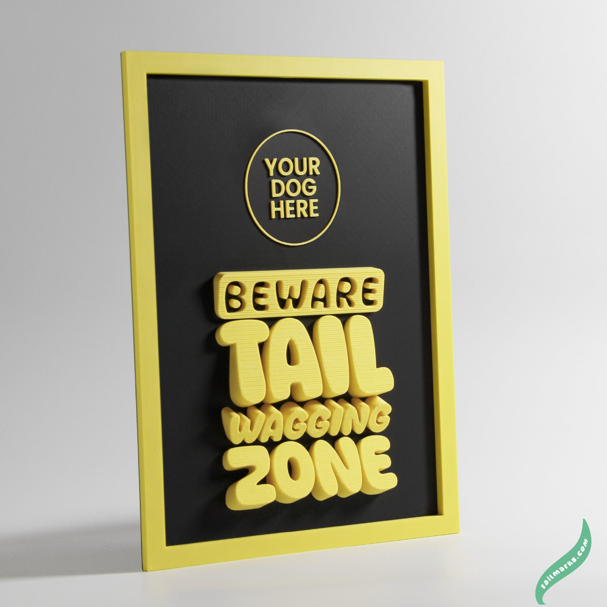 Framed artwork with 'Beware Tail Wagging Zone' text and a yellow border on a gray background.