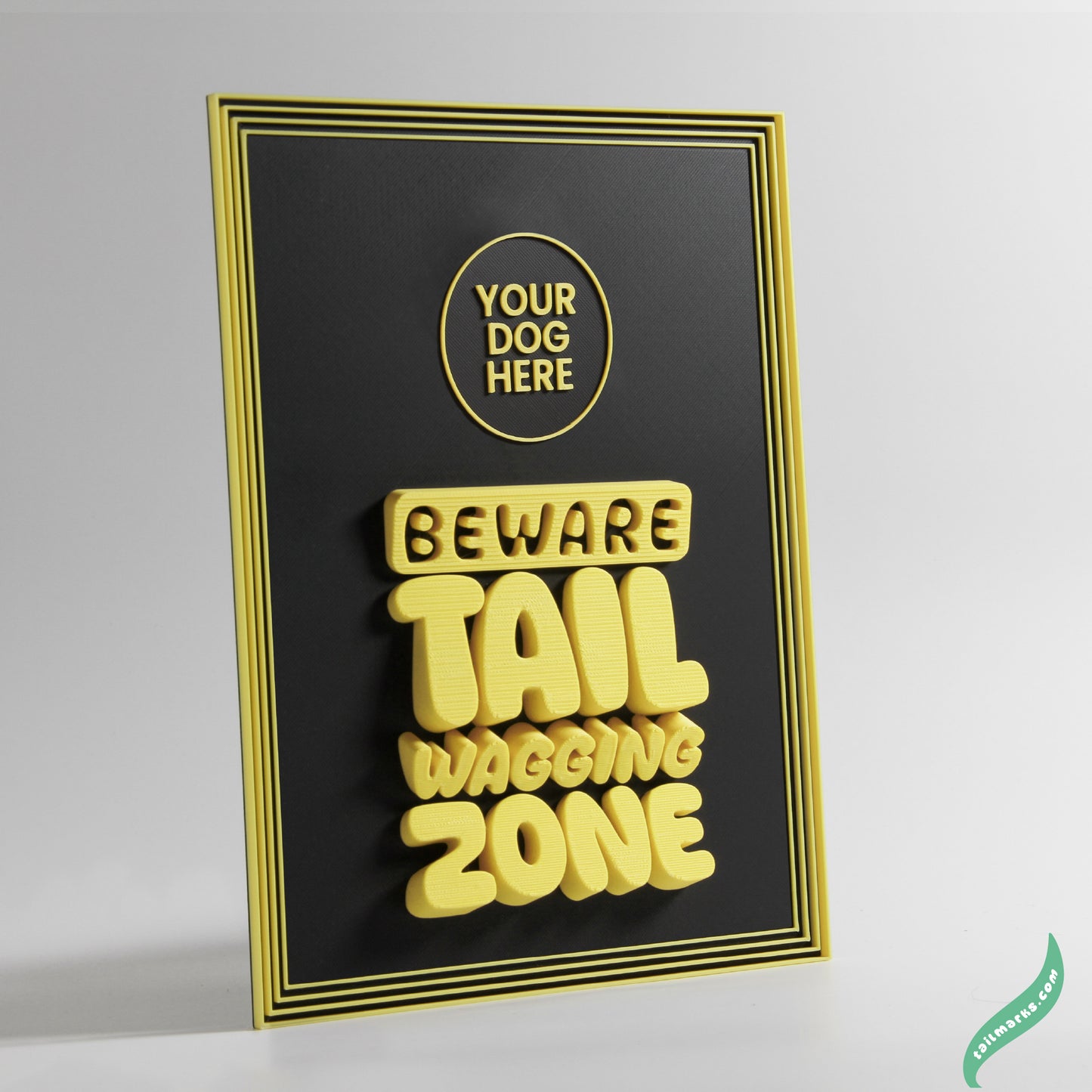Decorative sign with 'Beware Tail Wagging Zone' yeallow text on a black background and a focus frame